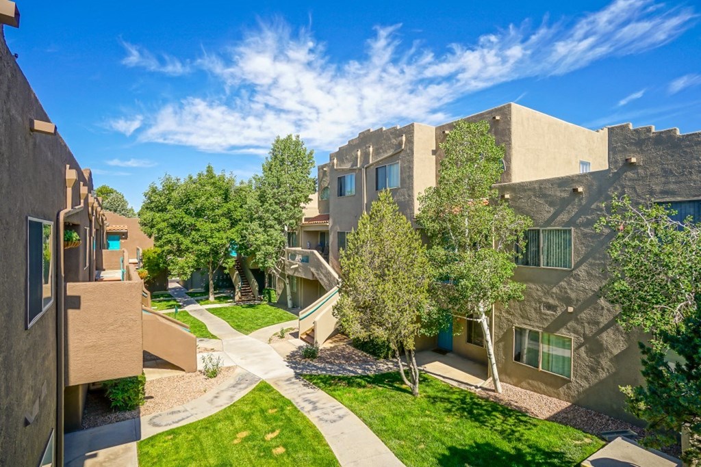 A sunny day in a courtyard surrounded by buildings.